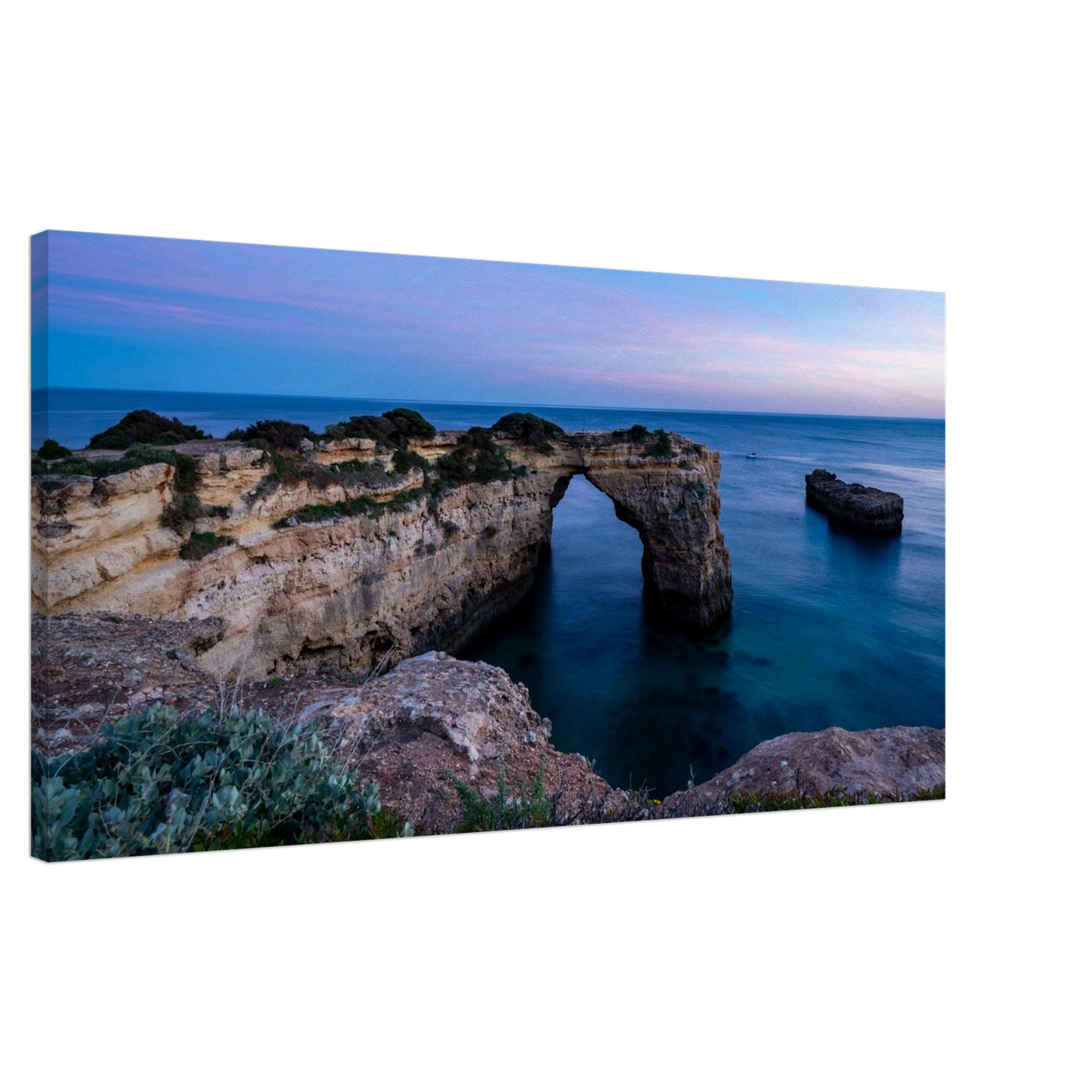 Sunset landscape photography of the sea arch at Praia de Albandeira in Portugal.